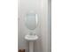 Clean and simple half-bathroom with a pedestal sink, oval mirror, and neutral wall color at 3870 County Down Ave, Kannapolis, NC 28081