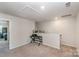 Versatile loft space with neutral carpet, a desk, and view into an adjacent bedroom at 3870 County Down Ave, Kannapolis, NC 28081