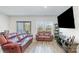 Comfortable living room with leather sofas, wood floors, natural light, and entertainment center at 3870 County Down Ave, Kannapolis, NC 28081