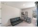Cozy living room featuring a black futon, storage shelving at 3870 County Down Ave, Kannapolis, NC 28081