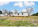 Back exterior of home with mature trees and partial yard at 405 Briarwood Ct, Mount Holly, NC 28120