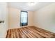 Bedroom with wood-look flooring, natural light, and neutral paint at 405 Briarwood Ct, Mount Holly, NC 28120