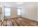 This is a spacious bedroom with natural light from the two windows at 405 Briarwood Ct, Mount Holly, NC 28120