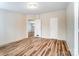 Bedroom with wood-look floors, white walls, and an open doorway at 405 Briarwood Ct, Mount Holly, NC 28120