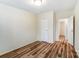 Empty bedroom with wood-look floors, white trim, and white walls at 405 Briarwood Ct, Mount Holly, NC 28120
