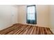 Cozy bedroom featuring wood-look flooring and natural light at 405 Briarwood Ct, Mount Holly, NC 28120
