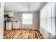 Open dining area with natural light, and wood floors next to the kitchen at 405 Briarwood Ct, Mount Holly, NC 28120