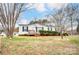 Inviting single-story residence showcases a well-maintained lawn and classic design elements, highlighting its comfortable living space at 405 Briarwood Ct, Mount Holly, NC 28120