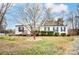 Charming single-story home featuring tidy landscaping, a covered porch, and traditional shutters for a welcoming curb appeal at 405 Briarwood Ct, Mount Holly, NC 28120