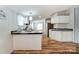 Bright kitchen with white cabinetry and modern appliances blends functionality and style with adjacent living area at 405 Briarwood Ct, Mount Holly, NC 28120