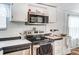 Well-equipped kitchen featuring stainless steel appliances, white cabinets, and marble countertops at 405 Briarwood Ct, Mount Holly, NC 28120
