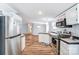 Spacious kitchen with stainless steel appliances and light wood flooring flowing into the living area at 405 Briarwood Ct, Mount Holly, NC 28120