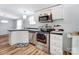 Bright kitchen showcasing stainless steel appliances, sleek countertops, and ample storage at 405 Briarwood Ct, Mount Holly, NC 28120