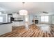 Bright open-concept living space with wood flooring, neutral walls, and a fireplace feature at 405 Briarwood Ct, Mount Holly, NC 28120