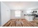 Open-concept living space with kitchen, dining, and living areas, wood floors, and natural light at 405 Briarwood Ct, Mount Holly, NC 28120
