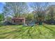 Expansive backyard featuring a shed, play area, and firepit with plenty of grassy space for recreation at 41 Selma Dr, Mooresville, NC 28115