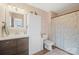 Well-lit bathroom featuring vanity, toilet and patterned shower curtain at 41 Selma Dr, Mooresville, NC 28115