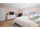 Sunlit bedroom featuring hardwood floors, large dresser and built in desk at 41 Selma Dr, Mooresville, NC 28115