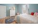 Inviting bedroom featuring a bright window, white dresser, wood floors, and decor for a comfortable space at 41 Selma Dr, Mooresville, NC 28115