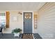 A quaint front porch featuring decor, plants, and a 'Home Sweet Home' welcome mat at 41 Selma Dr, Mooresville, NC 28115
