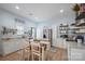 Bright kitchen with white cabinets, stainless steel appliances, and a dining table at 41 Selma Dr, Mooresville, NC 28115