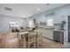Open-concept kitchen and living room with bright walls, wood floors, and a dining area at 41 Selma Dr, Mooresville, NC 28115