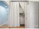 Functional laundry area with a washer, dryer, white cabinets, and a privacy curtain at 41 Selma Dr, Mooresville, NC 28115