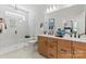 Modern bathroom featuring double vanity, a glass-enclosed shower, and contemporary fixtures at 411 Sunharvest Ln, Indian Trail, NC 28079