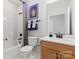 Bathroom with a shower and tub combination, wooden vanity, and stylish fixtures at 411 Sunharvest Ln, Indian Trail, NC 28079