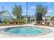 Community spa with a central fountain surrounded by landscaping and lounge chairs at 411 Sunharvest Ln, Indian Trail, NC 28079