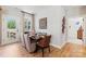 Dining room with seating for six, natural light, and modern decor at 411 Sunharvest Ln, Indian Trail, NC 28079