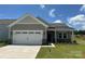 Charming home with a two-car garage, stone accents, and well-maintained landscaping at 411 Sunharvest Ln, Indian Trail, NC 28079