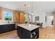 Bright kitchen features a center island, modern lighting, and stainless steel appliances at 411 Sunharvest Ln, Indian Trail, NC 28079
