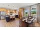 Open kitchen and dining area featuring stainless steel appliances, kitchen island, and a cozy dining table at 411 Sunharvest Ln, Indian Trail, NC 28079