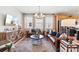 This is a living room area with two couches, hardwood floors, a coffee table, and a modern sideboard with television at 411 Sunharvest Ln, Indian Trail, NC 28079