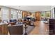 Open-concept living room and kitchen featuring modern furnishings, hardwood floors, and plenty of natural light at 411 Sunharvest Ln, Indian Trail, NC 28079