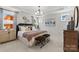 Bright and airy primary bedroom with a tray ceiling, accent furniture, and ample natural light at 411 Sunharvest Ln, Indian Trail, NC 28079
