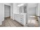 Bathroom featuring a white vanity with storage and neutral tile flooring, leading to the closet at 475 Union Baptist Church Rd, York, SC 29745