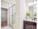Bathroom featuring a glass-enclosed shower, modern vanity, and a walk-in closet at 522 Fern Hill Rd # 17, Mooresville, NC 28117