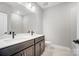 Bathroom with double sink vanity, dark wood cabinets, and a large mirror at 522 Fern Hill Rd # 17, Mooresville, NC 28117