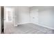 Neutral bedroom with carpeted floors, a closet, and an adjoining hallway with views of the staircase at 522 Fern Hill Rd # 17, Mooresville, NC 28117