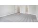 Neutral bedroom with light gray walls, carpeted floor, and paneled interior door at 522 Fern Hill Rd # 17, Mooresville, NC 28117