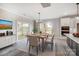 Bright dining room with sliding glass doors to the patio, wood table, and modern lighting at 522 Fern Hill Rd # 17, Mooresville, NC 28117