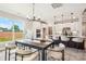 Bright dining area featuring an elegant chandelier and views of the outdoors, adjacent to modern kitchen at 522 Fern Hill Rd # 17, Mooresville, NC 28117