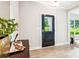 Light-filled entryway with modern door and view of the yard, complemented by light wood floors at 522 Fern Hill Rd # 17, Mooresville, NC 28117