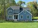 Charming blue two-story home with white trim, a gray roof, and a well-manicured lawn at 522 Fern Hill Rd # 17, Mooresville, NC 28117