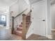 Hallway featuring carpeted stairs, light hardwood floors and white trim at 522 Fern Hill Rd # 17, Mooresville, NC 28117