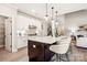 Modern kitchen with white cabinetry, stainless steel appliances, and a large island with bar seating at 522 Fern Hill Rd # 17, Mooresville, NC 28117