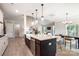 Open-concept kitchen with island, stainless appliances, and modern pendant lighting, blending seamlessly with living spaces at 522 Fern Hill Rd # 17, Mooresville, NC 28117