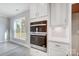 Modern kitchen featuring stainless steel double ovens and white cabinets with sleek hardware at 522 Fern Hill Rd # 17, Mooresville, NC 28117
